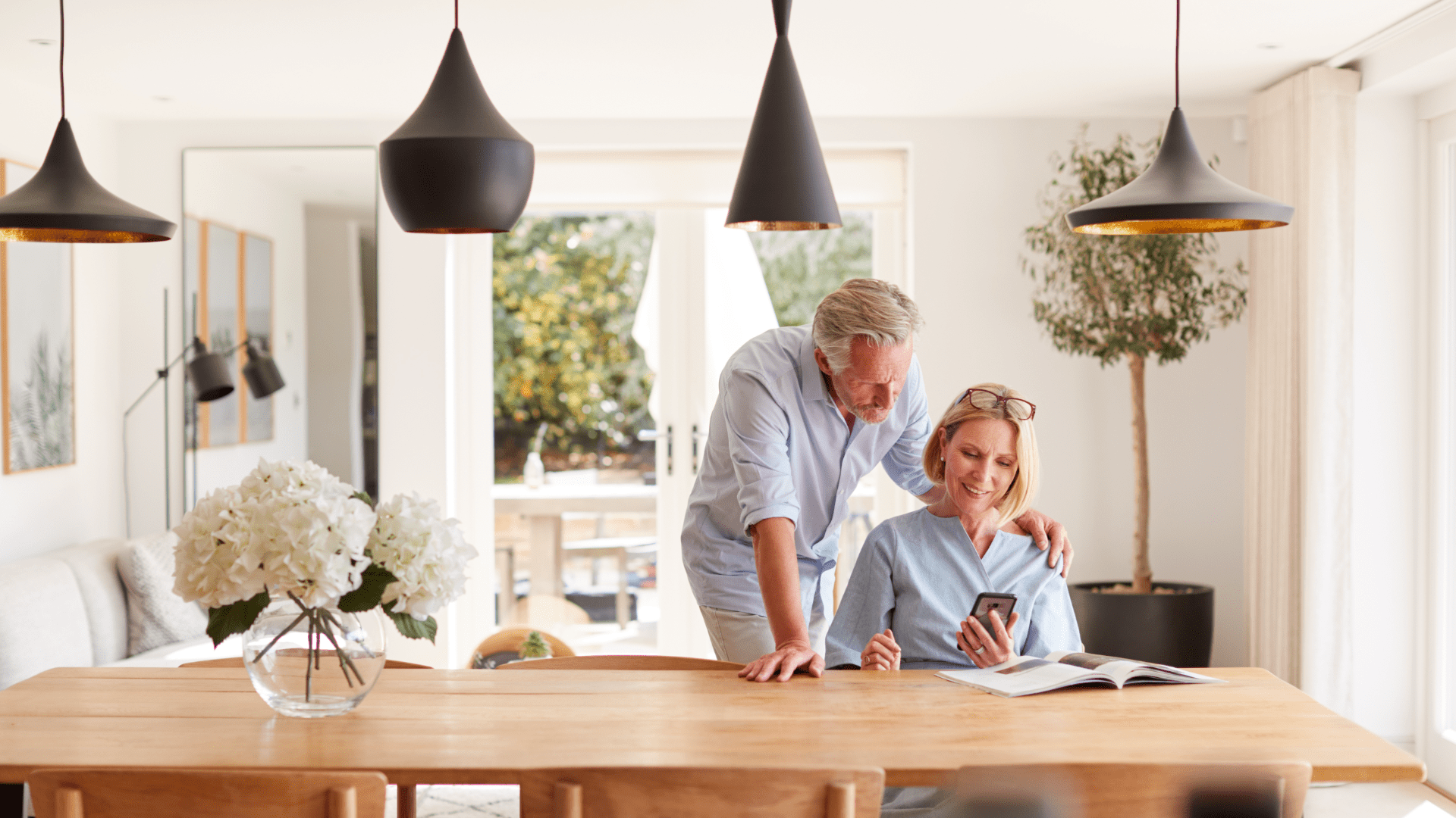 Couple-at-kitchen-table-looking-at-phone